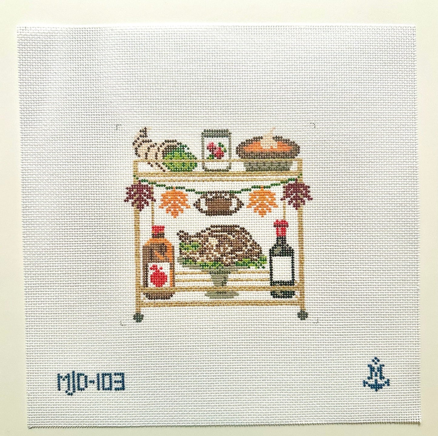 Needlepoint depiction of a bar cart with various items on a white background